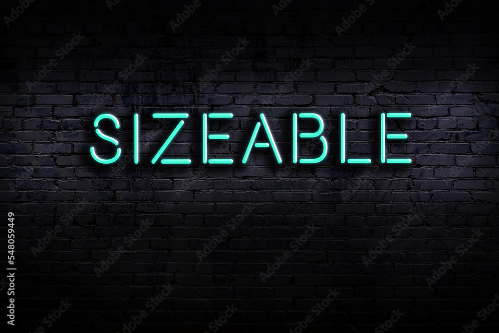 Φωτογραφία Neon sign. Word sizeable against brick wall. Night view