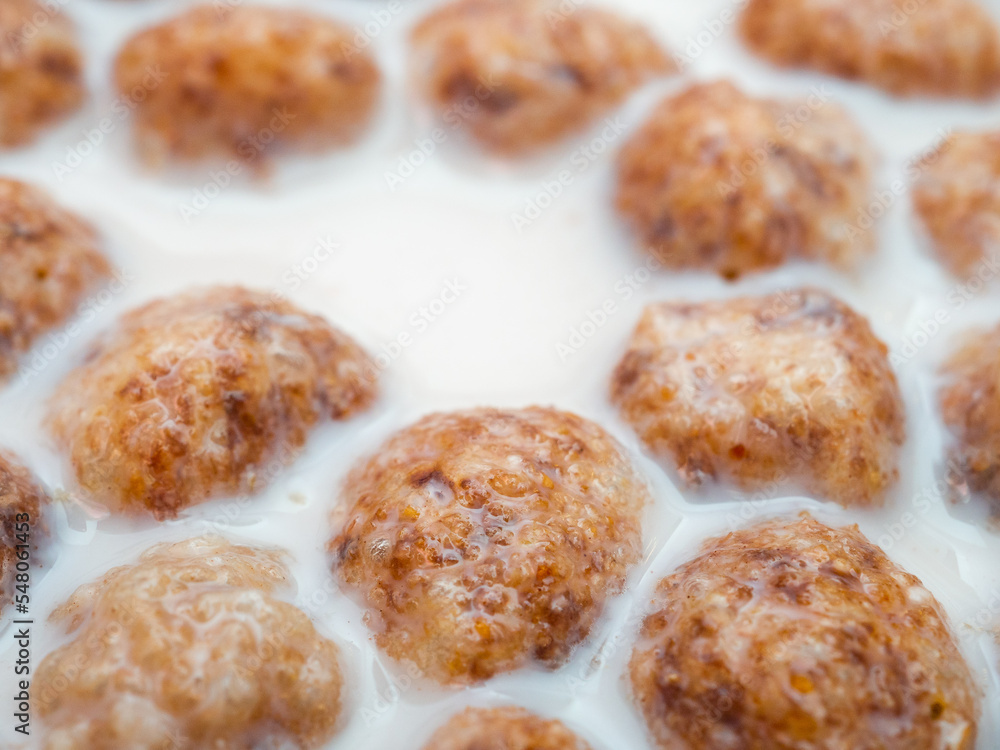 Swollen corn balls in milk close-up. Selective focus. Healthy breakfast of corn flakes and milk. Swollen corn balls in milk close-up. Selective focus. Healthy breakfast of corn flakes and milk.