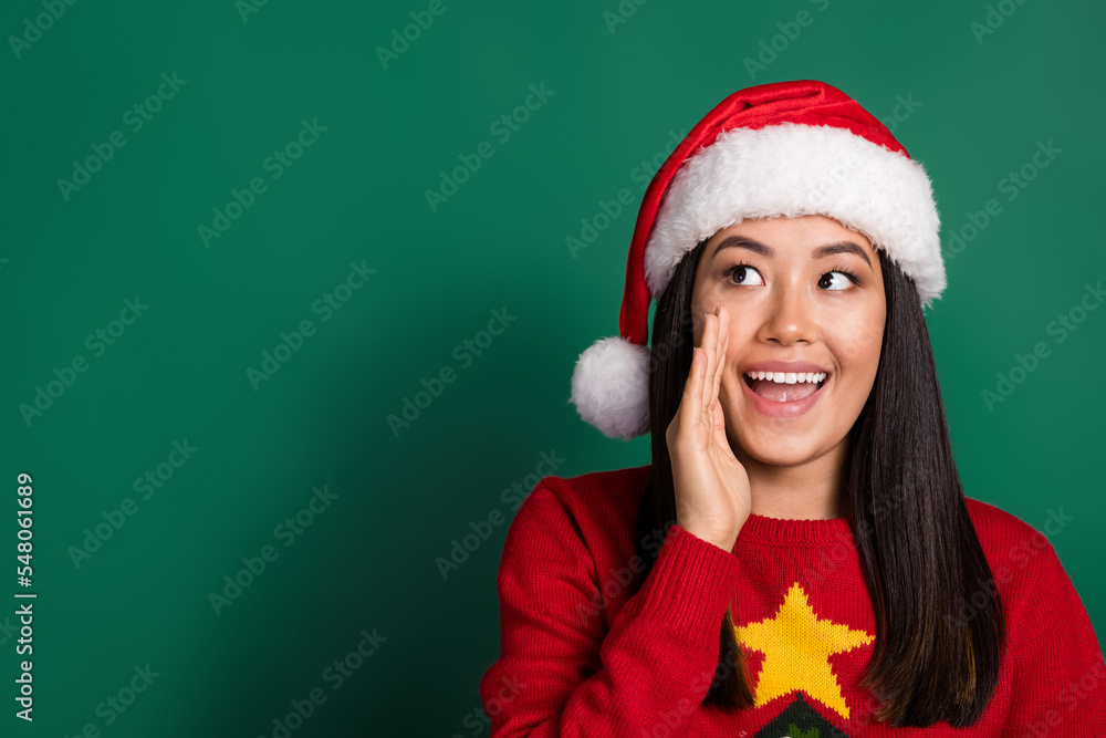 Portrait of cute cheerful nice woman with long hairdo wear red sweater hand on cheek look empty space isolated on green color background Portrait of cute cheerful nice woman with long hairdo wear red sweater hand on cheek look empty space isolated on green color background