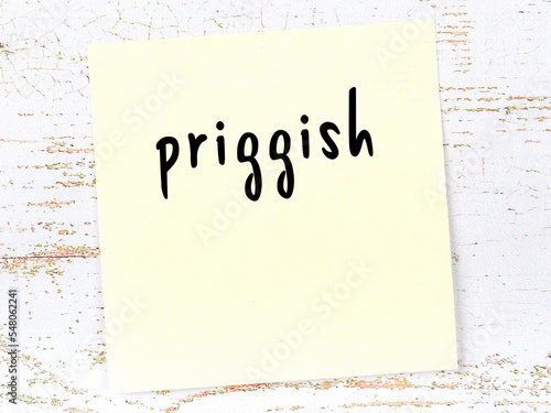 Yellow sheet of paper with word priggish. Reminder concept