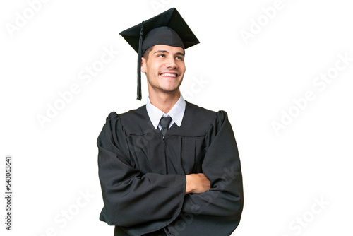Young university graduate caucasian man over isolated background looking up while smiling