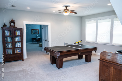 Cuadro en lienzo An upstairs loft air used as a bonus game room with a pool table and cabinet