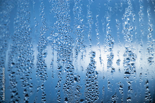 Texture of misted glass in autumn. Drops of water on window in rainy weather.