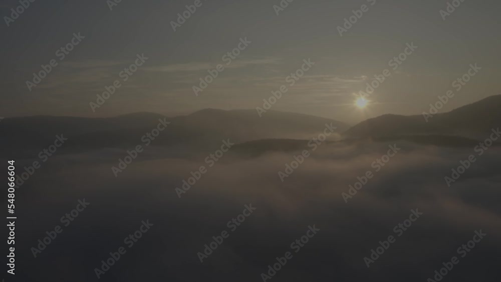 Flying Towards Midnight Sun Above The Clouds. Aerial view Flying Towards Midnight Sun Above The Clouds. Aerial view