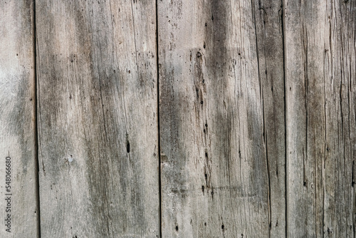 Background in the form of old wooden boards. Dilapidated rotten boards in the form of a wall or fence. Free space for text. Background of dry wood in the form of boards nailed to each other