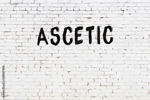 Fototapete Inscription ascetic painted on white brick wall