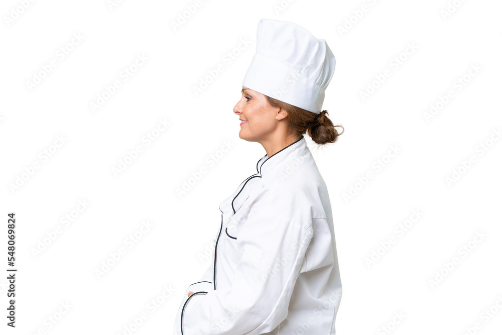 Middle-aged chef woman over isolated background in lateral position Middle-aged chef woman over isolated background in lateral position