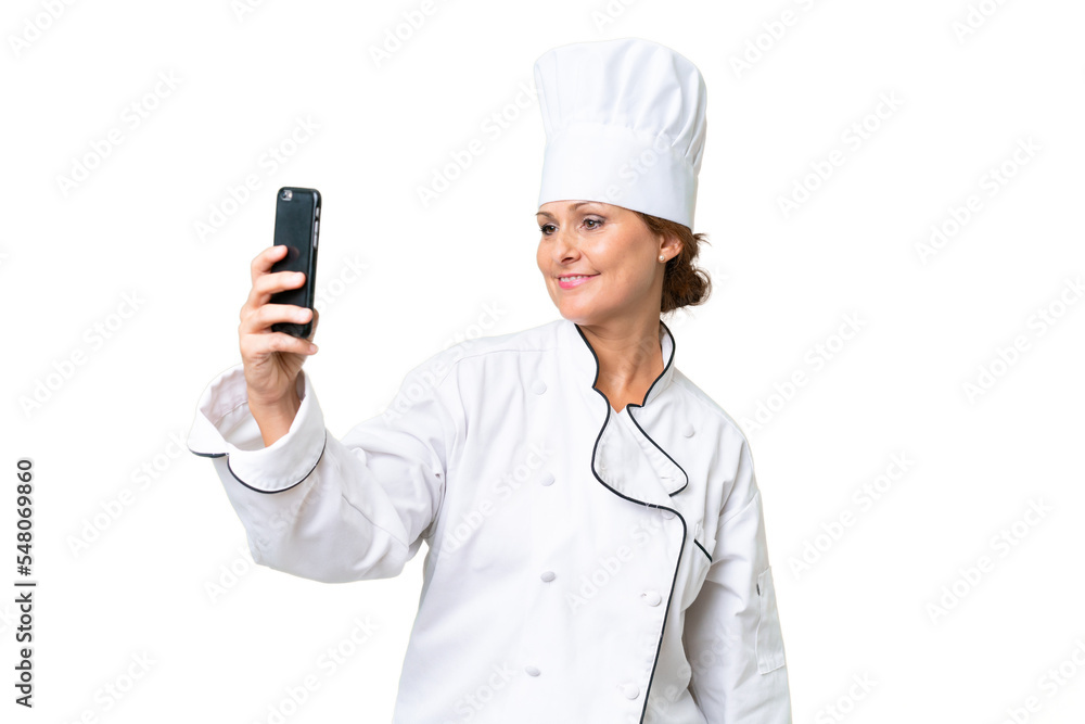 Middle-aged chef woman over isolated background making a selfie Middle-aged chef woman over isolated background making a selfie