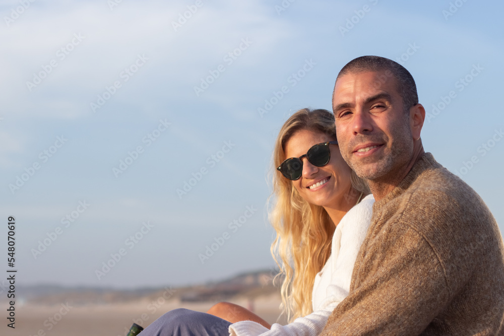 Portrait of stylish friends on beach. Fashionable male and female models looking at camera. Style, friendship concept