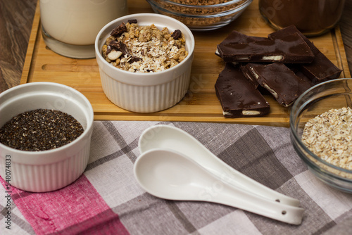Bowl of chocolate granola with milk and other ingredients