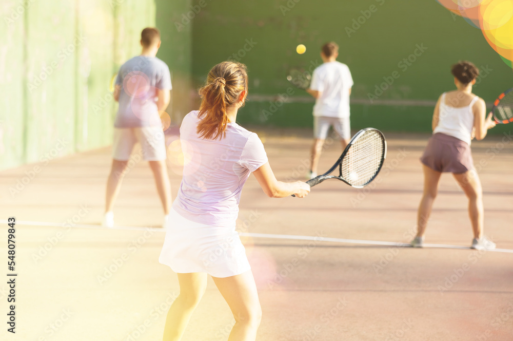 Latin woman playing frontenis on outdoor pelota court during training. Woman playing Basque pelota speciality.