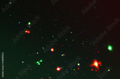 red and green christmas holiday lights bokeh overlay on a black background