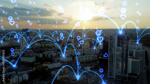Social media emoji icons appear in different parts of the city. The center of the city united by a common global network. Concept of online community, wireless network, mobile technology.