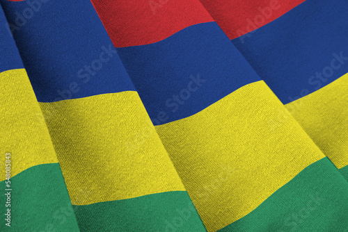 Mauritius flag with big folds waving close up under the studio light indoors. The official symbols and colors in banner photo