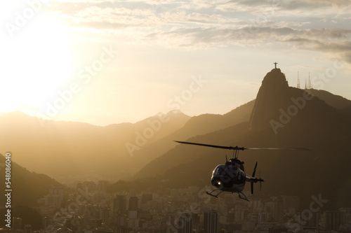 Helicopter at sunset with Christ the Redeemer in Rio de Janeiro in the background