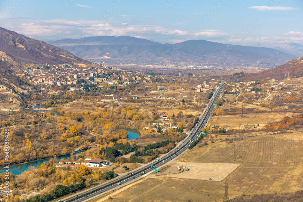 highway with cars among mountainous terrain
