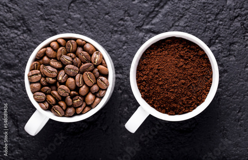 Roasted coffee beans and ground coffee, on dark background, closeup image, space for text