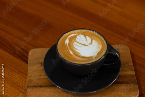 hot latte art coffee on wood table  relax time