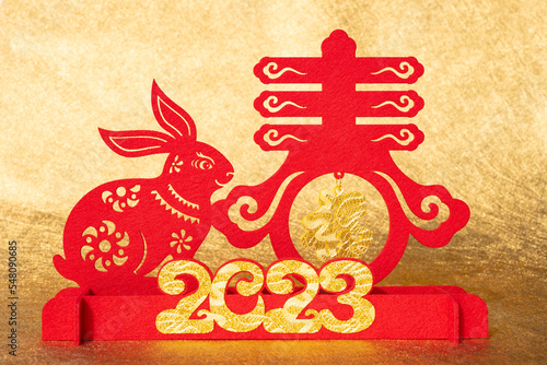 Chinese New Year of Rabbit mascot paper cut on golden background translation of Fototapet