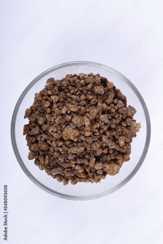 Bowl of unprocessed muscovado rocks against a white background Bowl of unprocessed muscovado rocks against a white background