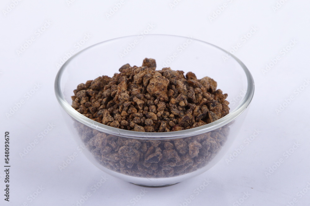 Bowl of unprocessed muscovado rocks against a white background Bowl of unprocessed muscovado rocks against a white background