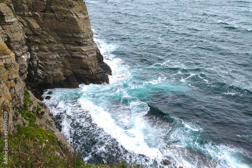 The sea waves are beating against the rocks. Aerial view of ocean waves and fantastic Rocky coast 