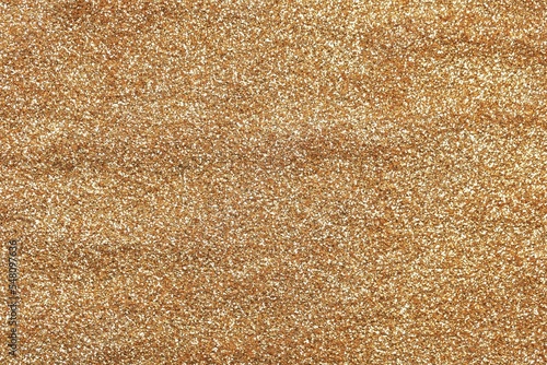 Beautiful golden shiny glitter as background, top view