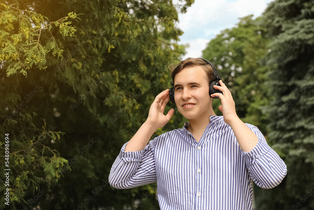 Handsome young man with headphones outdoors on sunny day Handsome young man with headphones outdoors on sunny day