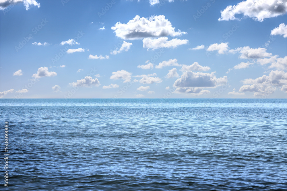 Obraz premium Beautiful view of seascape and blue sky with white clouds on sunny day