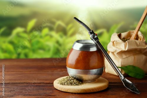 Принти на полотні Calabash with mate tea and bombilla on wooden table outdoors