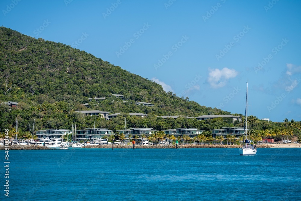 tourist boats and tour boats in the whitsundays queensland, australia. travellers on the great barrier reef, over coral and fish. tourism yachts of young people partying on the water