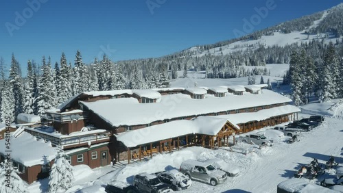 Aerial above Towgotee Mountain Lodge in winter on sunny beautiful day in Moran, Wyoming photo