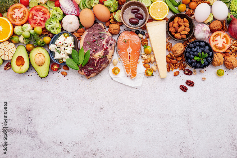 Ketogenic low carbs diet concept. Ingredients for healthy foods selection set up on white concrete background. Ketogenic low carbs diet concept. Ingredients for healthy foods selection set up on white concrete background.