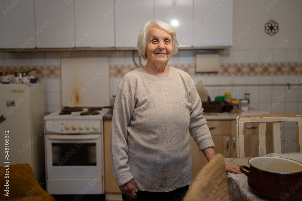 one woman senior old female caucasian pensioner standing at home waist up portrait looking to the camera dementia alzheimer's disease concept positive emotion copy space one woman senior old female caucasian pensioner standing at home waist up portrait looking to the camera dementia alzheimer's disease concept positive emotion copy space