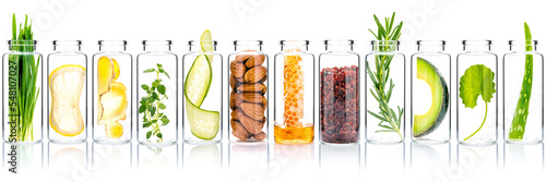 Fototapeta Homemade skin care with natural ingredients avocado ,cucumber ,honeycomb ,almonds ,centella asiatica, ginger slice and rosemary  in glass bottles isolate on white background