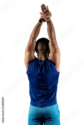 Portrait from behind of a Latino man in blue sportswear stretching his arms