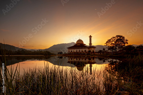 Landscape of Sunrise near Mosque and mountain. photo