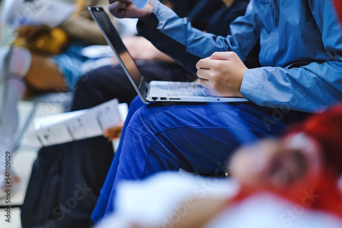 Canvas Print Student using laptop to answer questions online and doing interactive group studying in a workshop training session