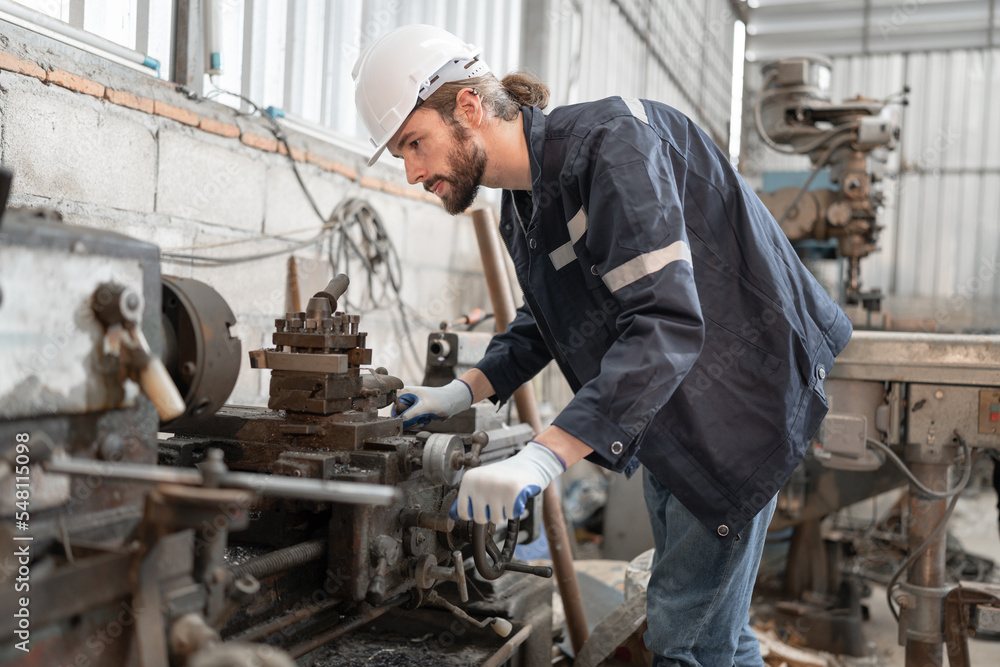 Caucasian engineer man checking with lathe machine at lathe factory Caucasian engineer man checking with lathe machine at lathe factory