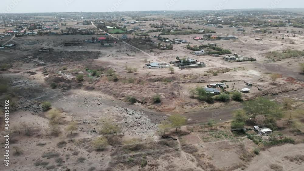 drone flight over powerlines in a desert landscape towards a city. drone wide shot drone flight over powerlines in a desert landscape towards a city. drone wide shot
