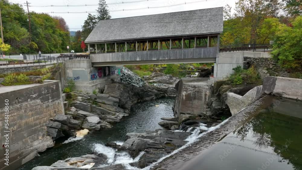 Quechee Vermont covered bridge. Aerial view of waterfall and historic site. Quechee Vermont covered bridge. Aerial view of waterfall and historic site.