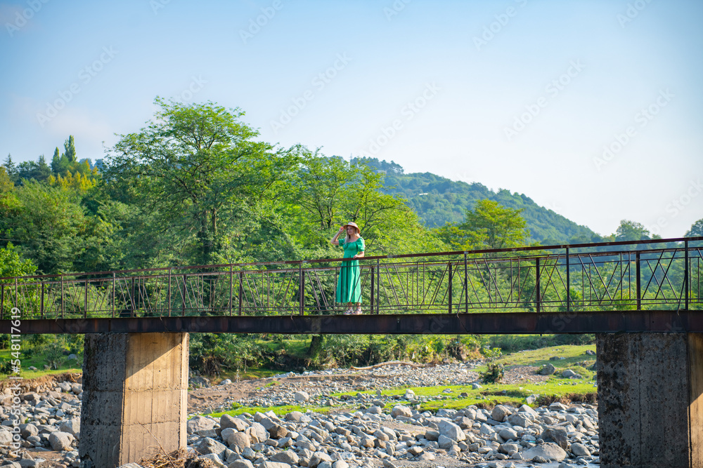 one girl is standing on the bridge