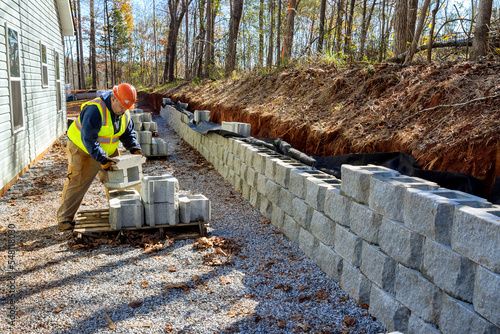 Photos Contractor was seen installing concrete block wall that is being built on part n