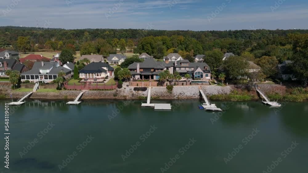 Waterfront homes in private gated community in deep south USA. Aerial of mansions with private boat dock on river. Waterfront homes in private gated community in deep south USA. Aerial of mansions with private boat dock on river.