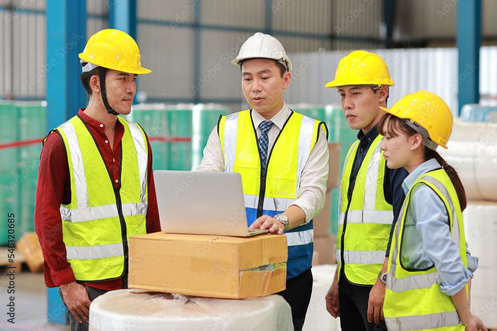 Group of technician engineer and businessman in protective uniform standing and discussing, researching, brainstorming and planning work together with computer at industry manufacturing factory Group of technician engineer and businessman in protective uniform standing and discussing, researching, brainstorming and planning work together with computer at industry manufacturing factory