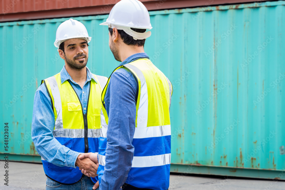 Two male engineers in a container shipping company Consulting to check the order for the container that is responsible
Two male engineers in a container shipping company Consulting to check the order for the container that is responsible