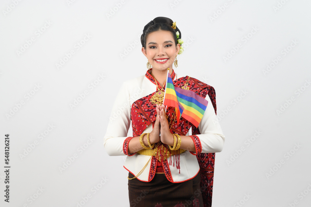 Portrait of Young woman in Thai Northeastern Traditional Clothing holding rainbow flag Portrait of Young woman in Thai Northeastern Traditional Clothing holding rainbow flag