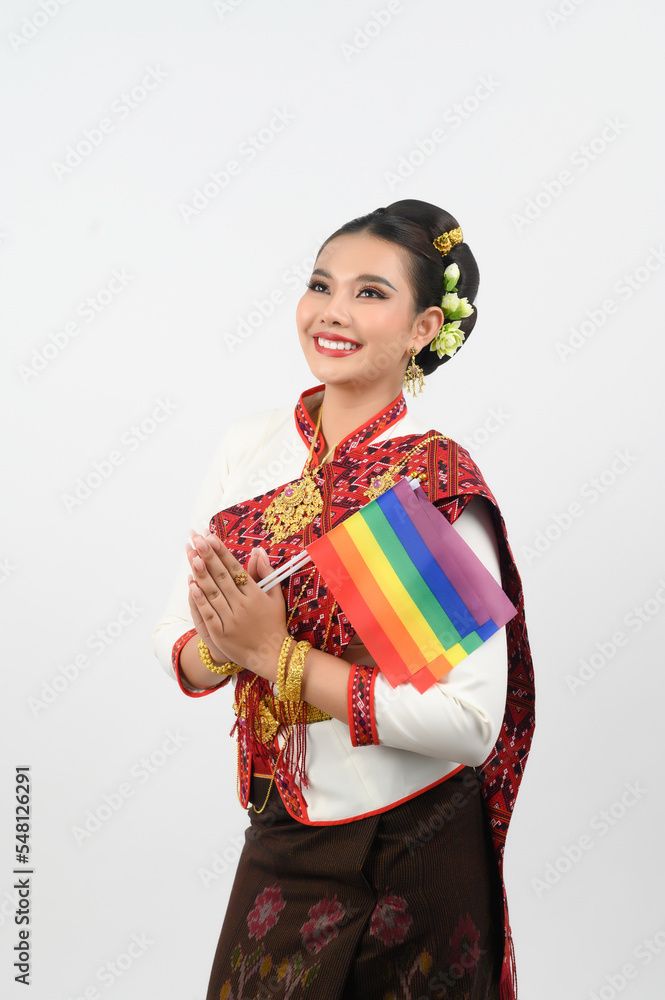 Portrait of Young woman in Thai Northeastern Traditional Clothing holding rainbow flag Portrait of Young woman in Thai Northeastern Traditional Clothing holding rainbow flag