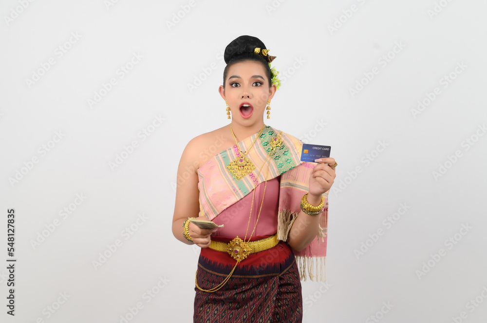 Portrait of Beautiful Thai Woman in Traditional Clothing Posing with banknote and credit card Portrait of Beautiful Thai Woman in Traditional Clothing Posing with banknote and credit card