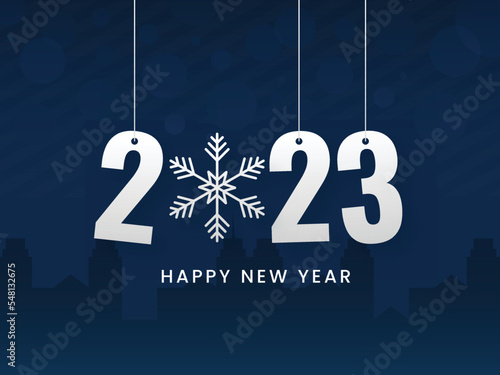 2023 Number Hang With Snowflake Against Blue Silhouette Buildings Background.